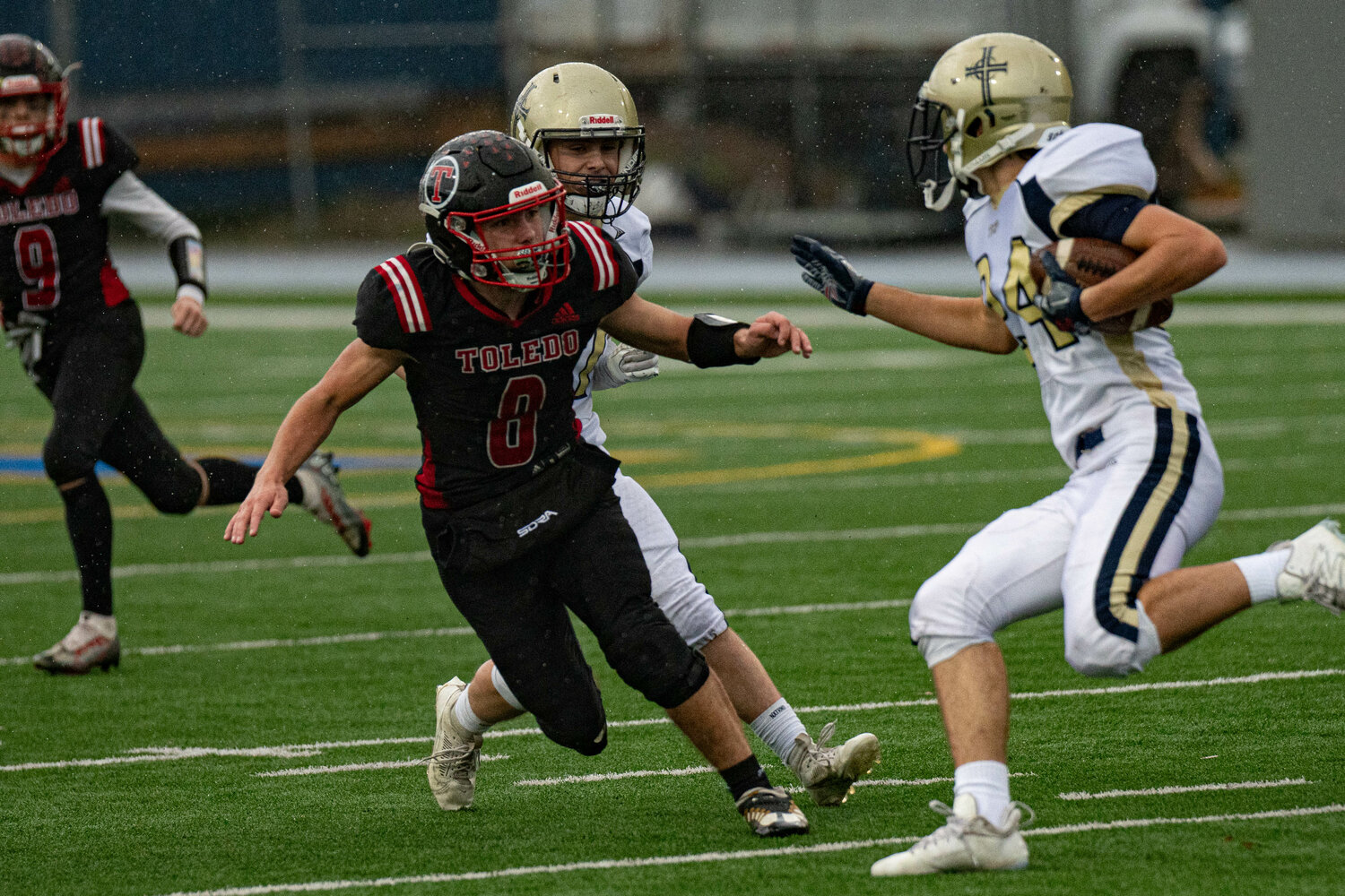 Toledo's Ethen Carver attempts a tackle during a 21-12 victory over Tri Cities Prep Nov. 11